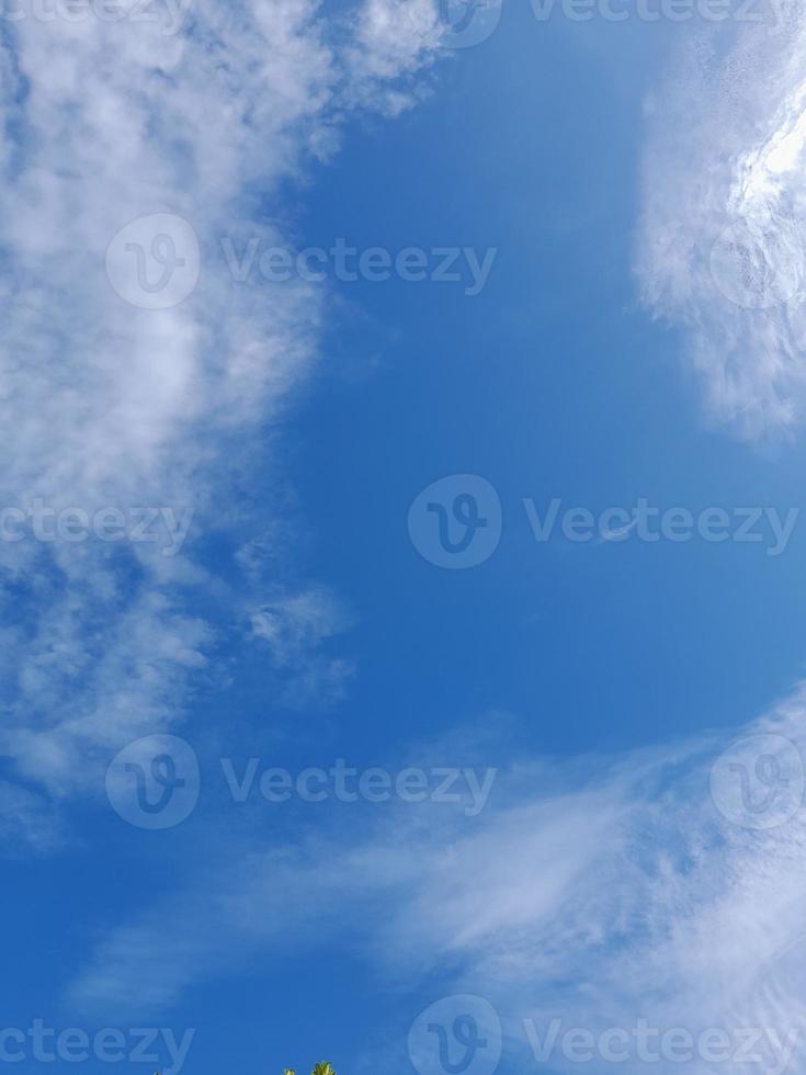Beautiful white clouds on deep blue sky background. Large bright soft fluffy clouds are cover the entire blue sky. photo