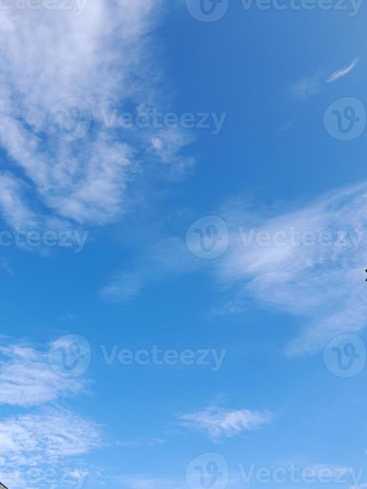 Beautiful white clouds on deep blue sky background. Large bright soft fluffy clouds are cover the entire blue sky. photo