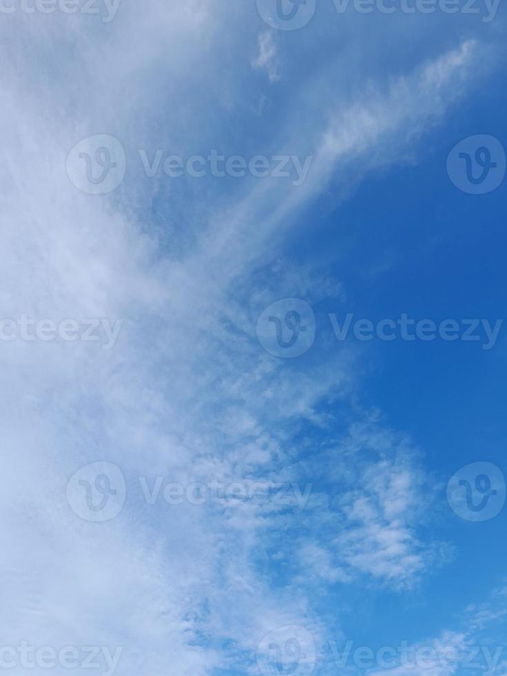 Beautiful white clouds on deep blue sky background. Large bright soft fluffy clouds are cover the entire blue sky. photo