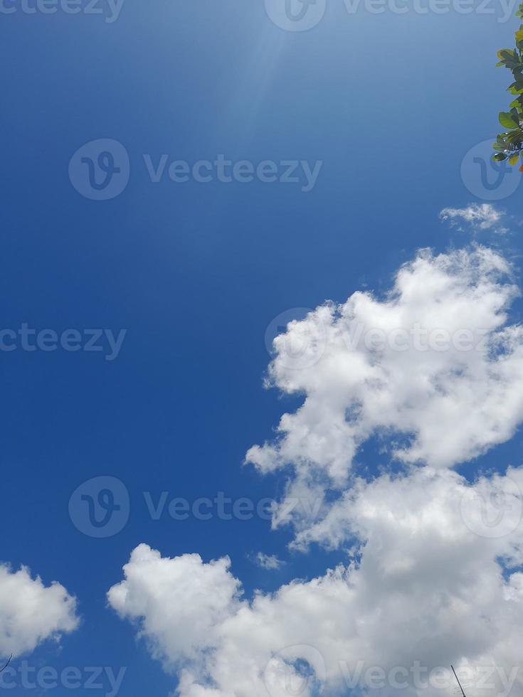 Beautiful white clouds on deep blue sky background. Large bright soft fluffy clouds are cover the entire blue sky. photo