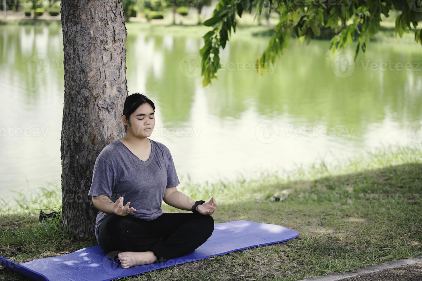 Beautiful asian fat woman play yoga at the park,Need to slim fit