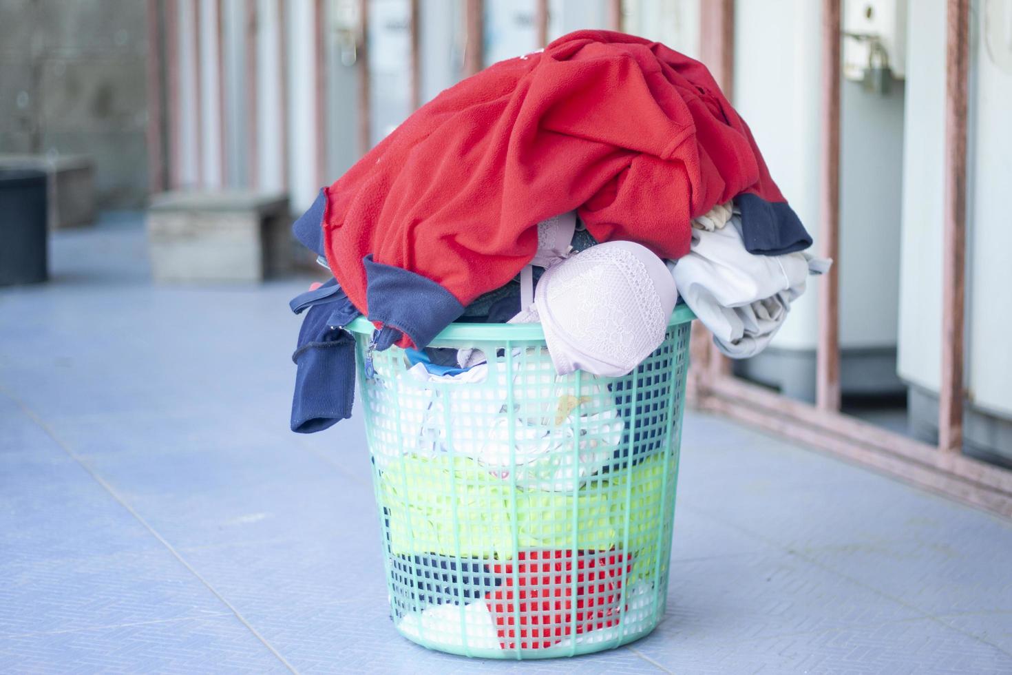 Overflow laundry cloth plastic basket, prepare to washing machine. photo