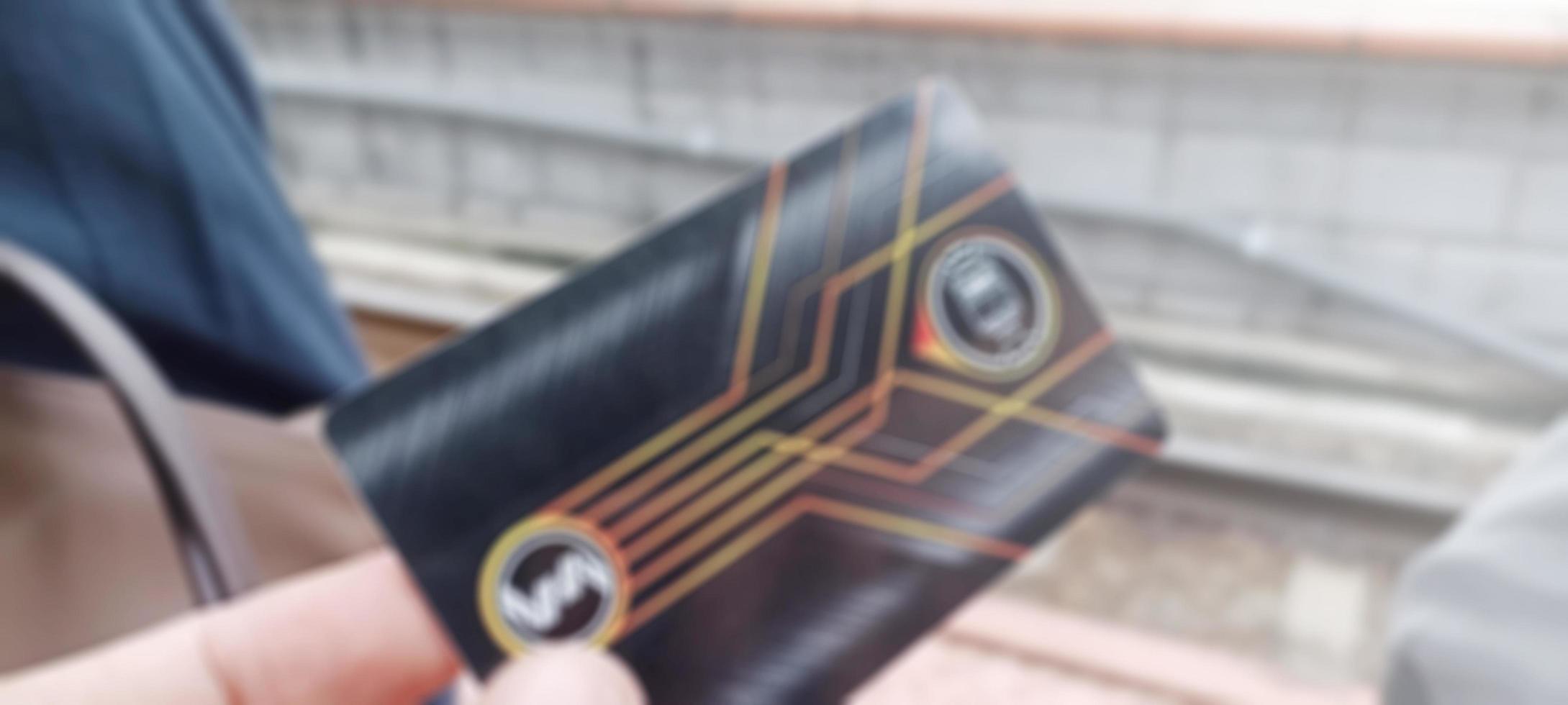 Jakarta, Indonesia. April 2, 2023. Photo of an Electric Train ticket with railroad tracks in the background