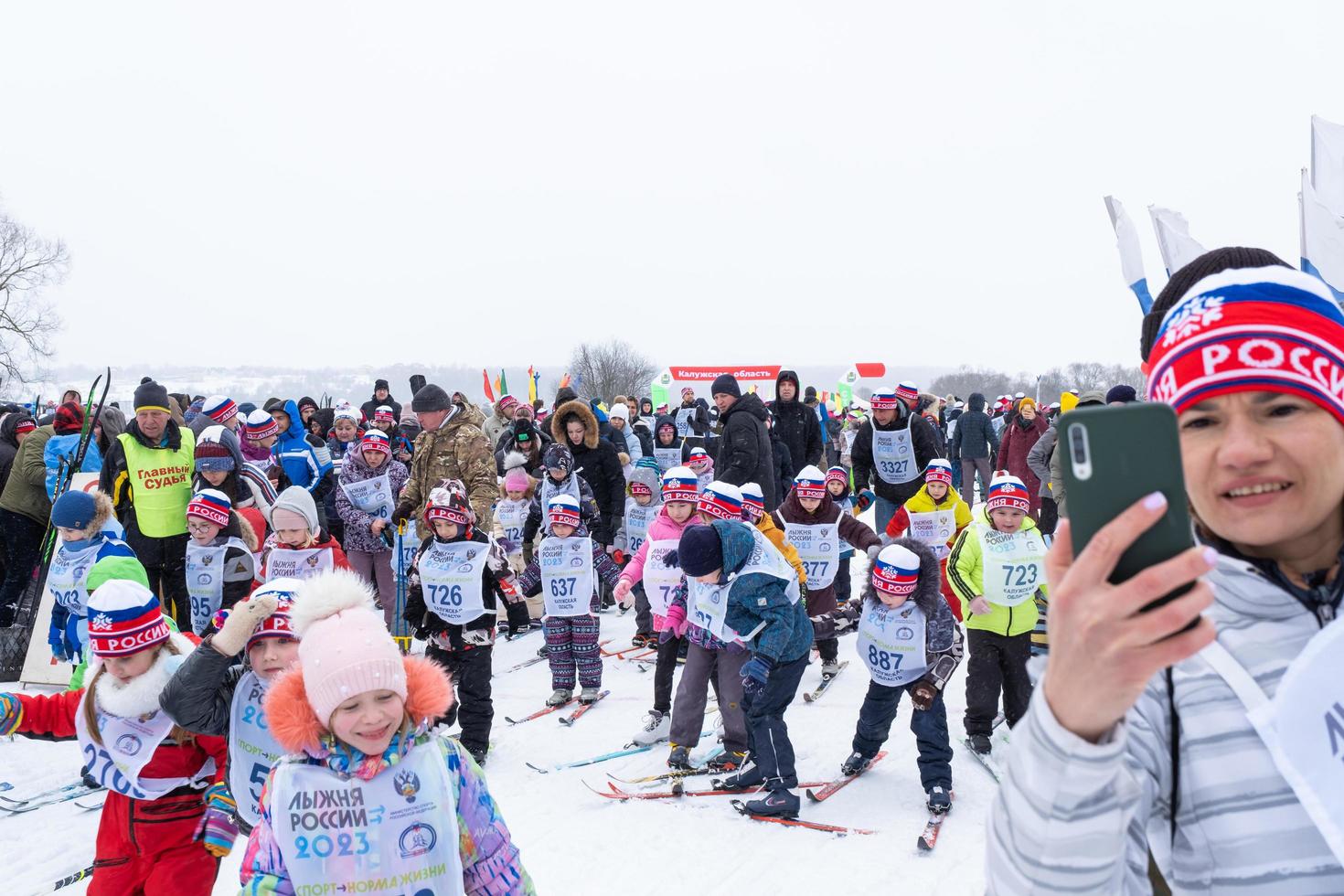 Annual All-Russian sports event action Ski Track of Russia. Sporty lifestyle for adults, children, family holiday on cross-country skiing - mass race on a snowy track. Russia, Kaluga - March 4, 2023 photo