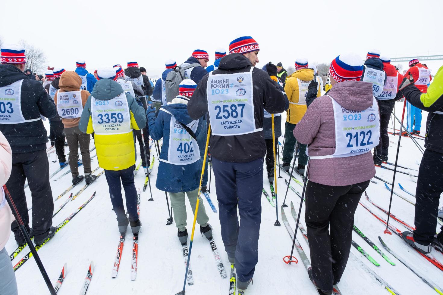 Annual All-Russian sports event action Ski Track of Russia. Sporty lifestyle for adults, children, family holiday on cross-country skiing - mass race on a snowy track. Russia, Kaluga - March 4, 2023 photo