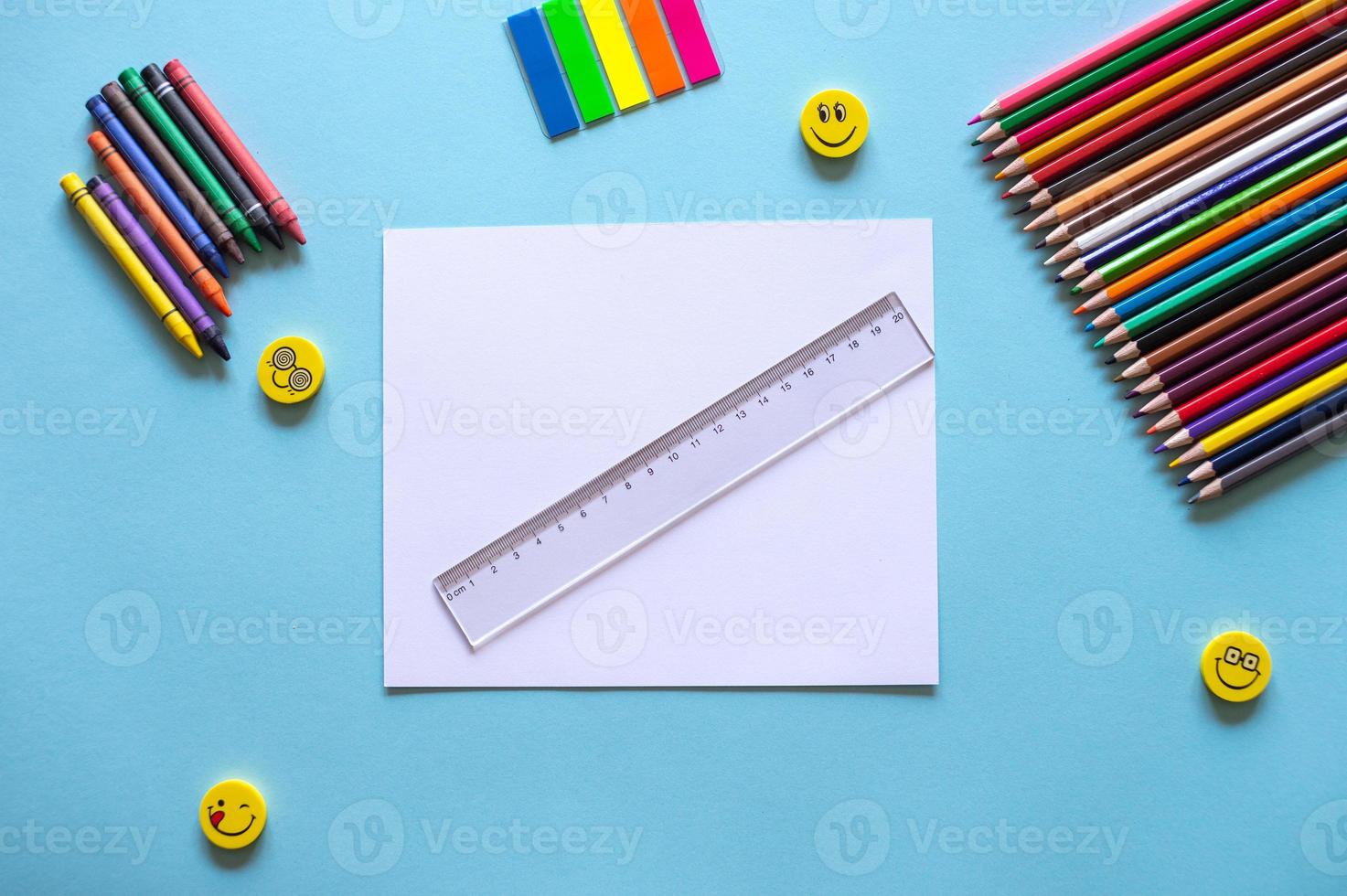 A set of bright stationery items on a blue background. Colour pencils photo