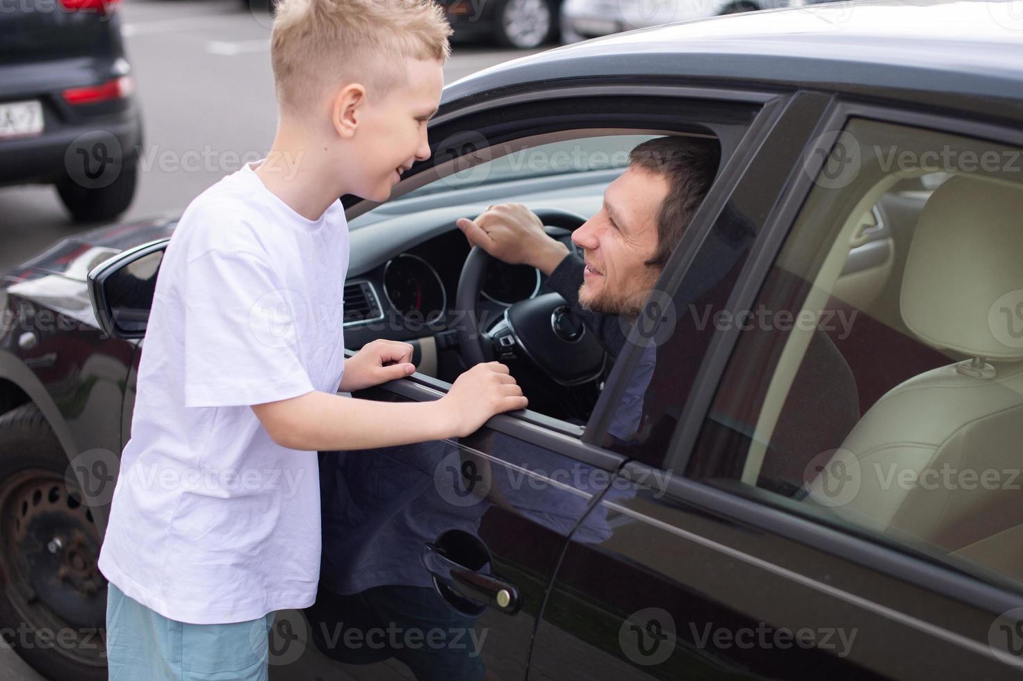 Dad came home in a black car. Son meets Father photo