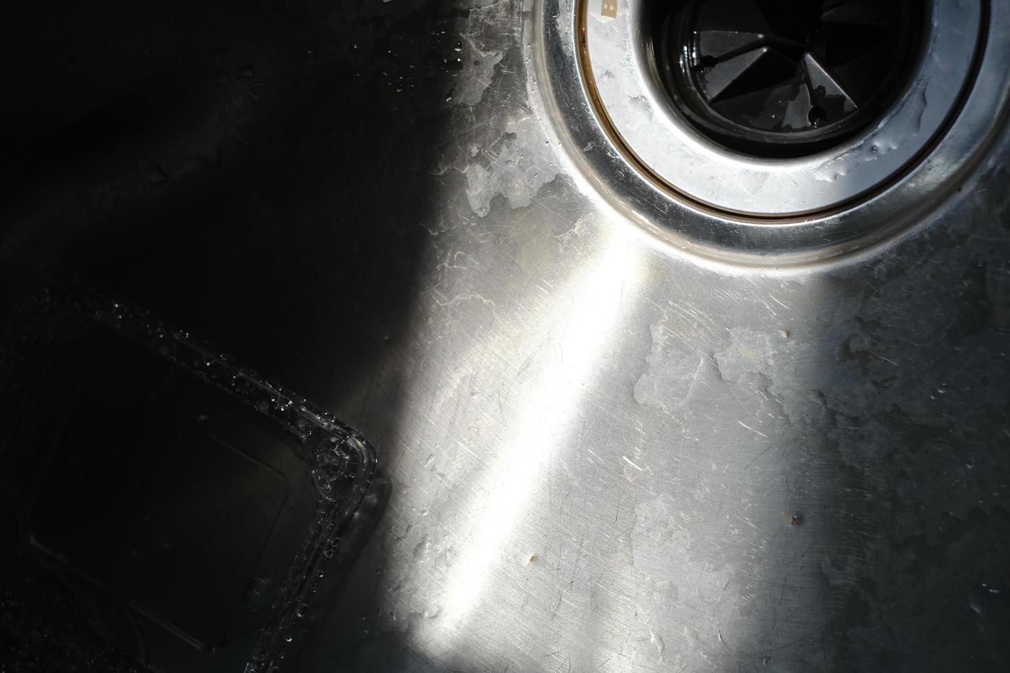 A stainless steel pool under a beam of light photo