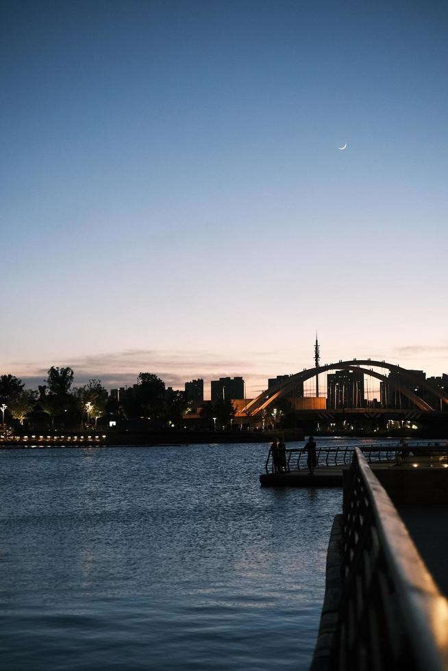 Deep blue water of Harbour Bridge at sunset photo