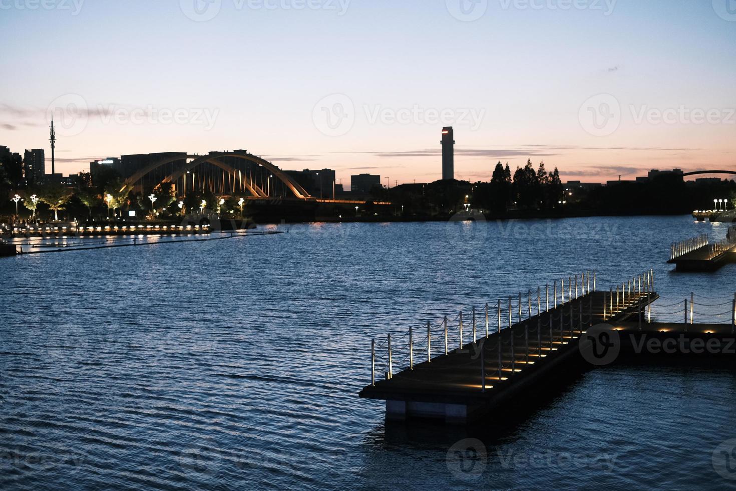 Deep blue water of Harbour Bridge at sunset photo