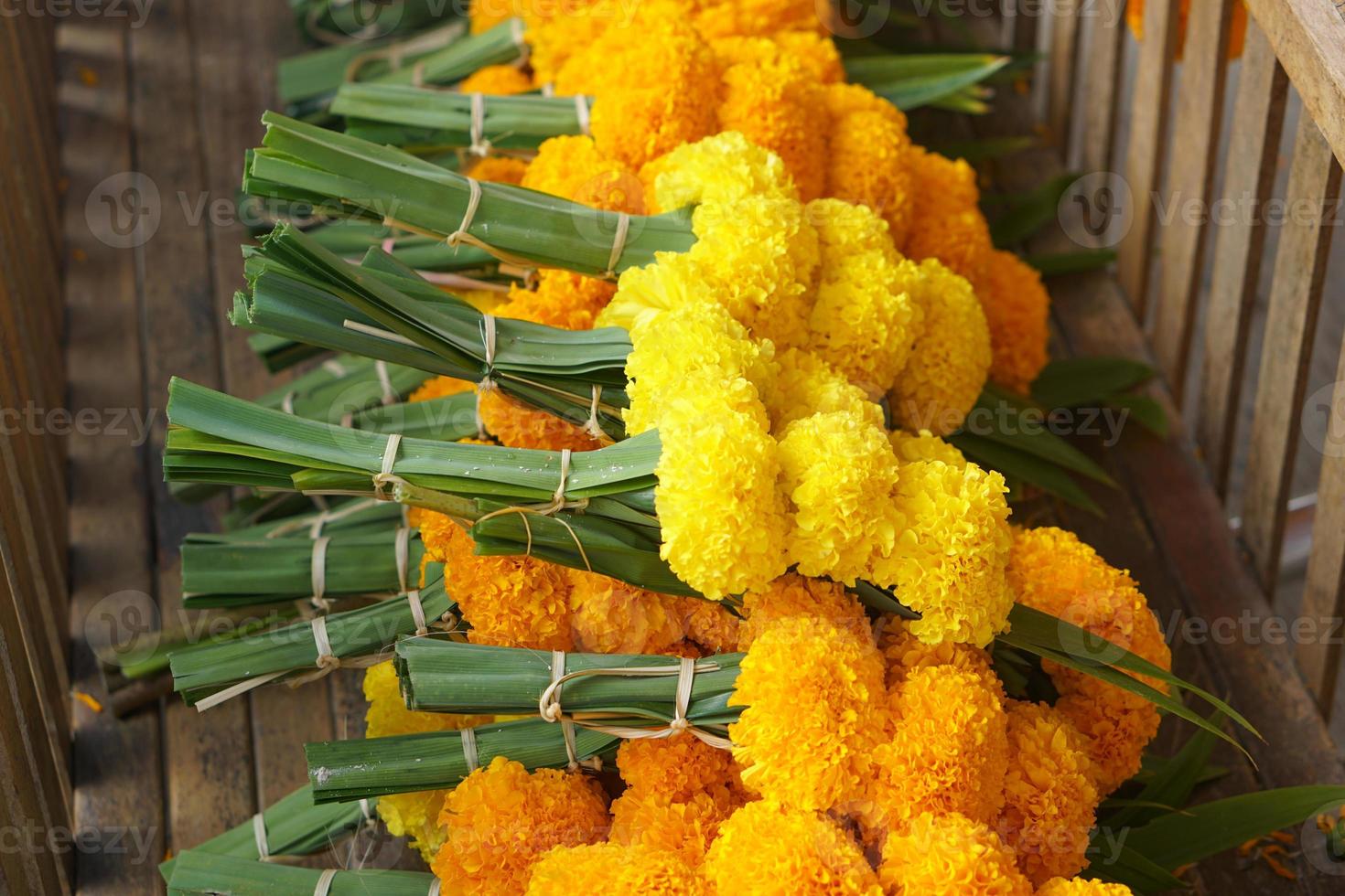 Marigolds, lotus flowers are brought to pay homage to the Lord Buddha. photo