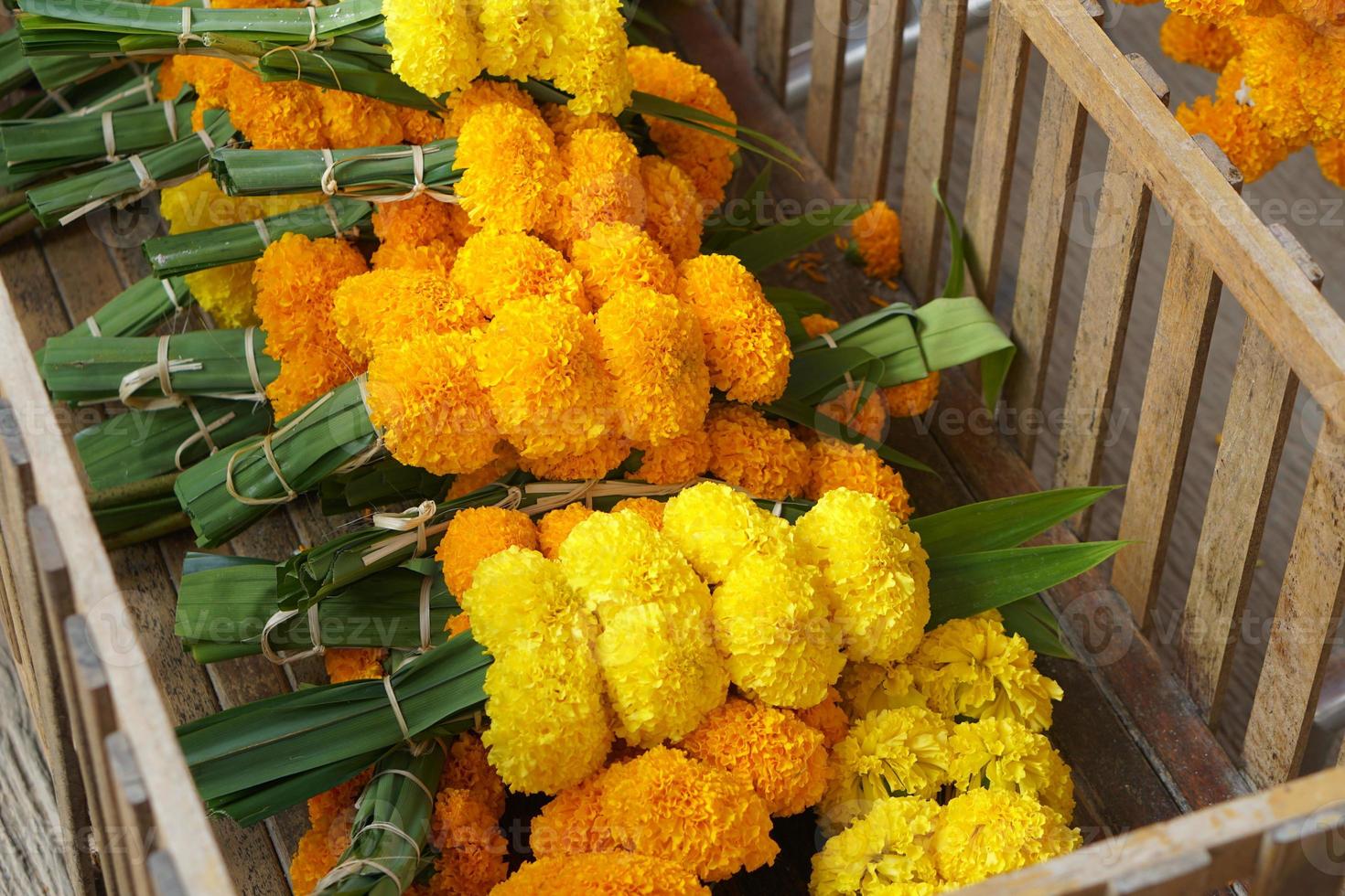Marigolds, lotus flowers are brought to pay homage to the Lord Buddha. photo