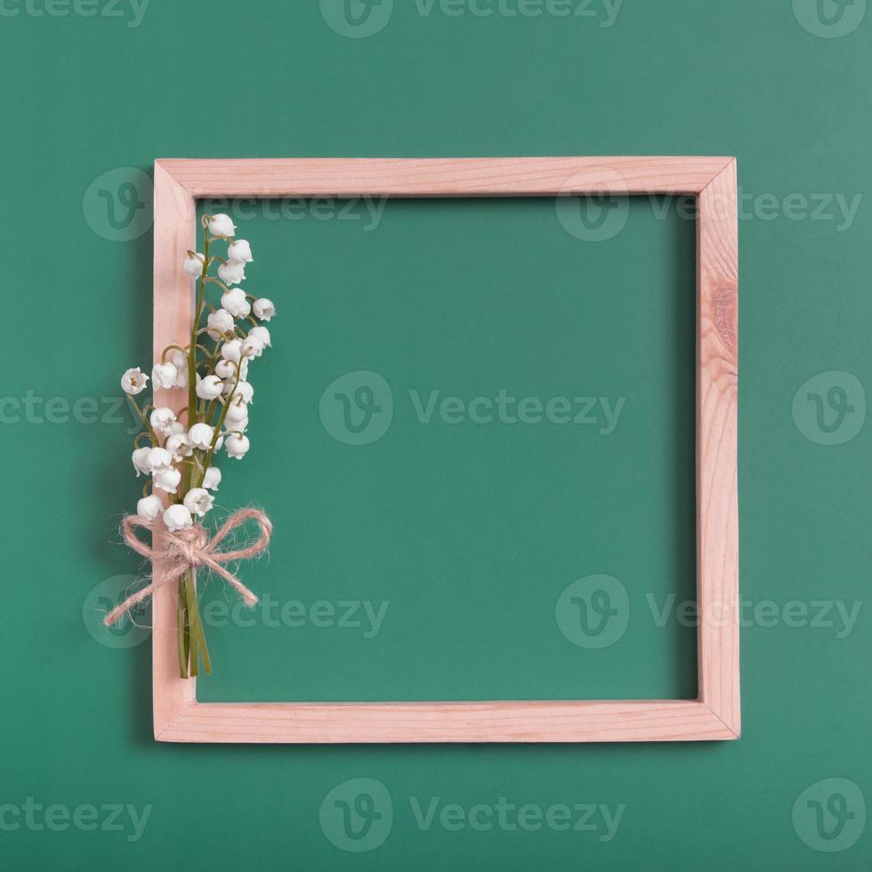 Summer or spring composition. Lily of the valley with square frame copy space top view. Summer, spring floral concept photo