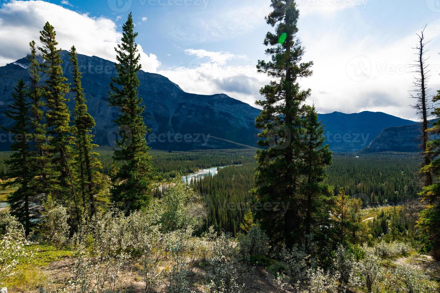 Tunnel Mountain Hoodoos Lookout in Alberta, Canada with stunning mountains and blue sky photo