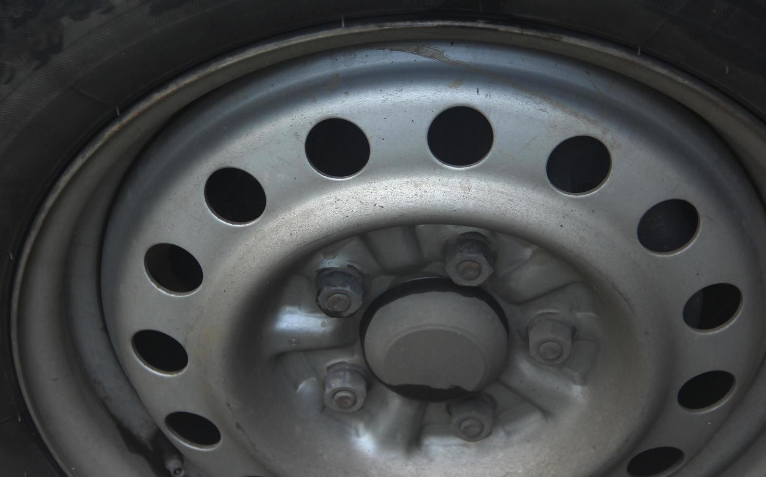 Close up modern steel and rubber car van transportation vehicle tire wheel isolated photo on landscape background.