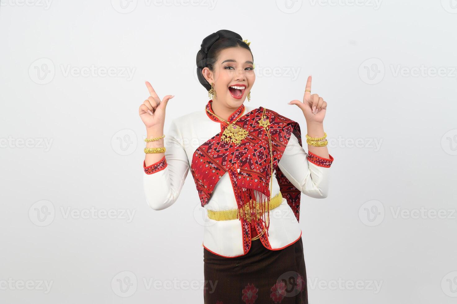Young beautiful woman in northeastern dress stand and point finger posture photo