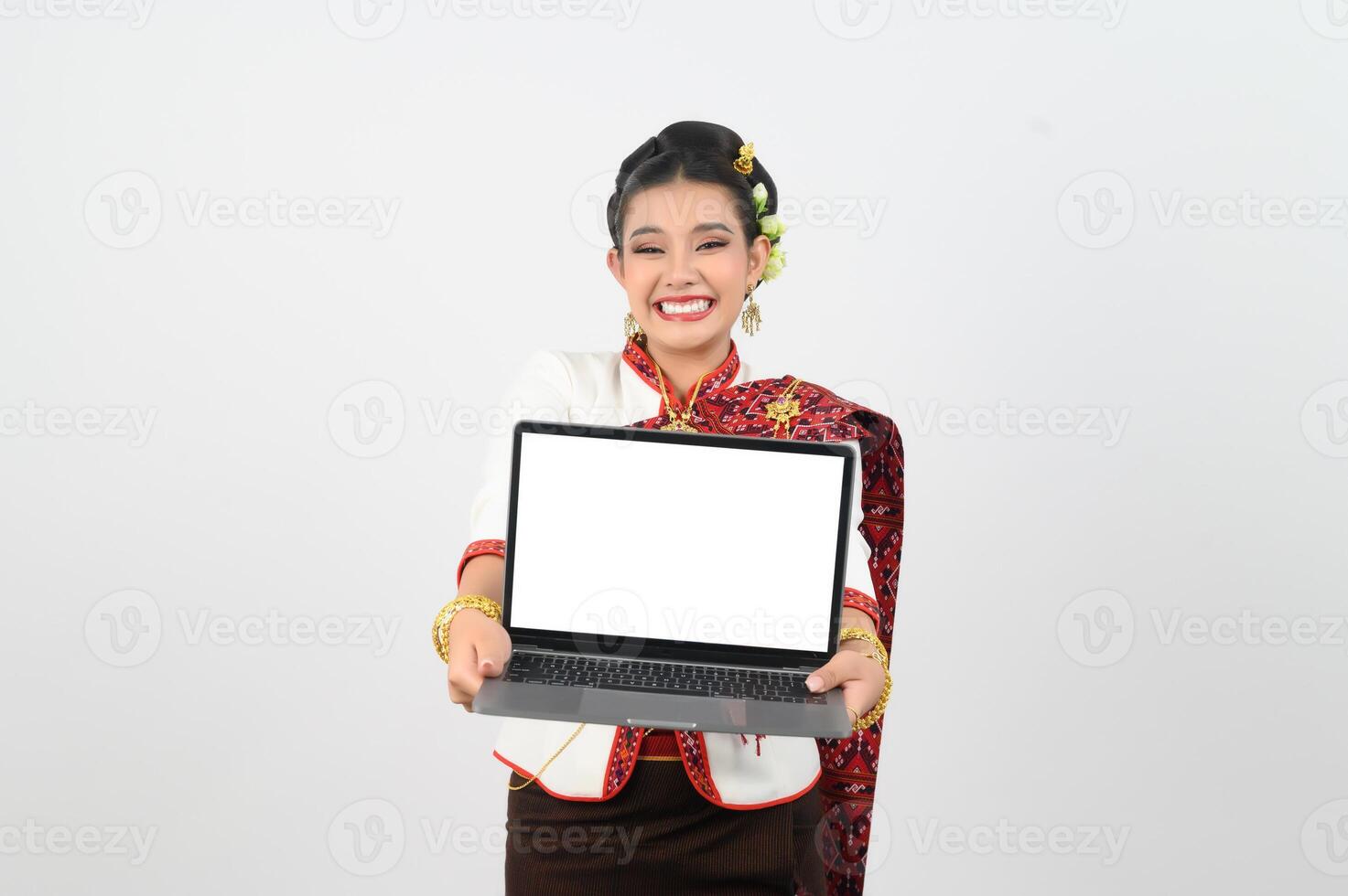 Portrait of Beautiful Thai Woman in Traditional Clothing Posing with laptop computer photo