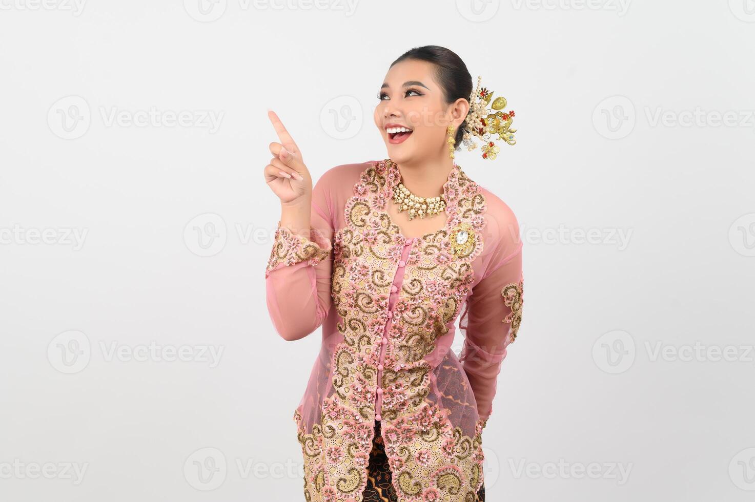 Young beautiful woman dress up in local culture in southern region point finger posture photo