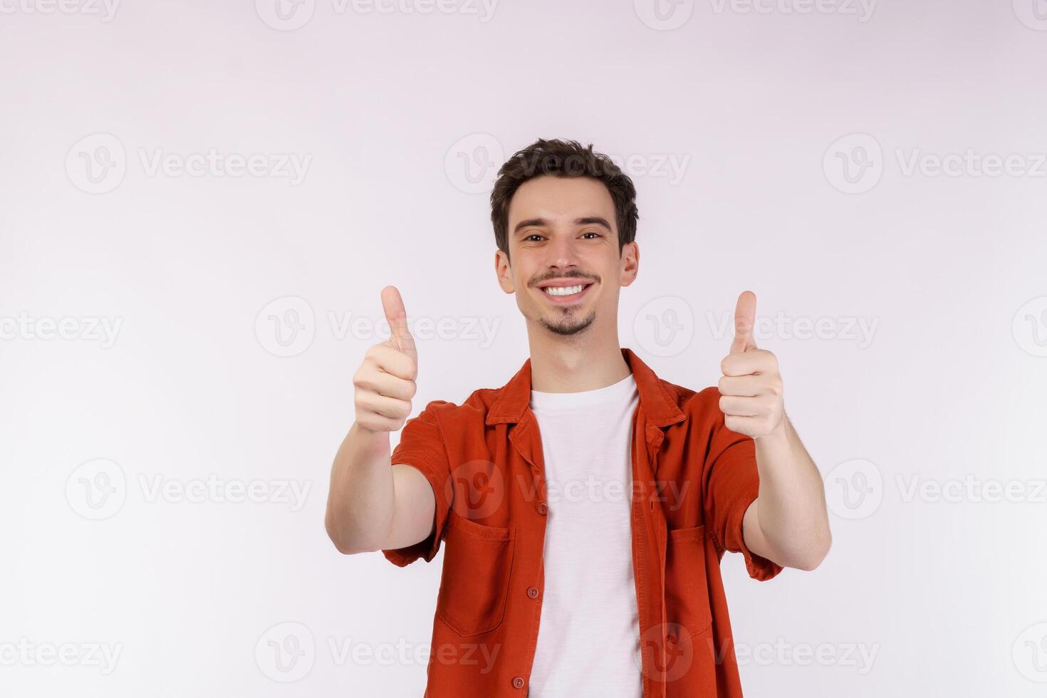 Portrait of happy smiling young man showing thumbs up gesture and looking at camera on isolated over white background photo