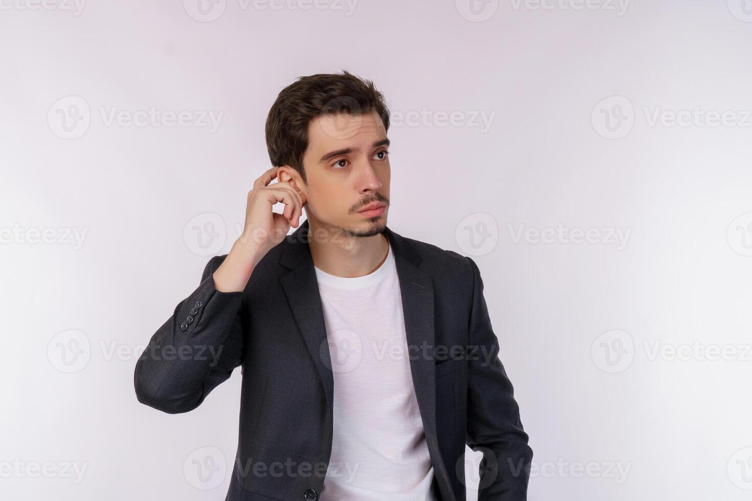 Portrait of thinking man surrounded by question mark on isolated background photo