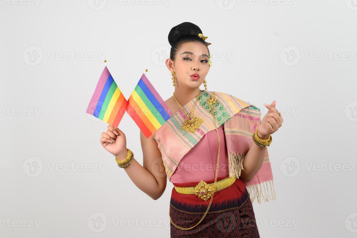 Portrait of Young woman in Thai Northeastern Traditional Clothing holding rainbow flag photo