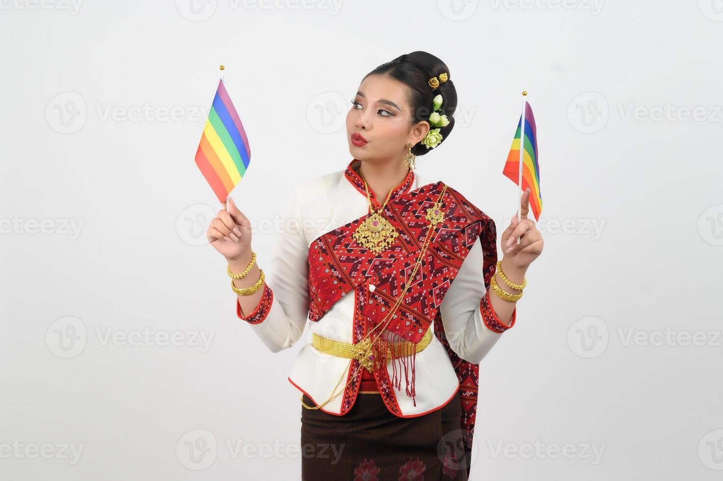 Portrait of Young woman in Thai Northeastern Traditional Clothing holding rainbow flag photo