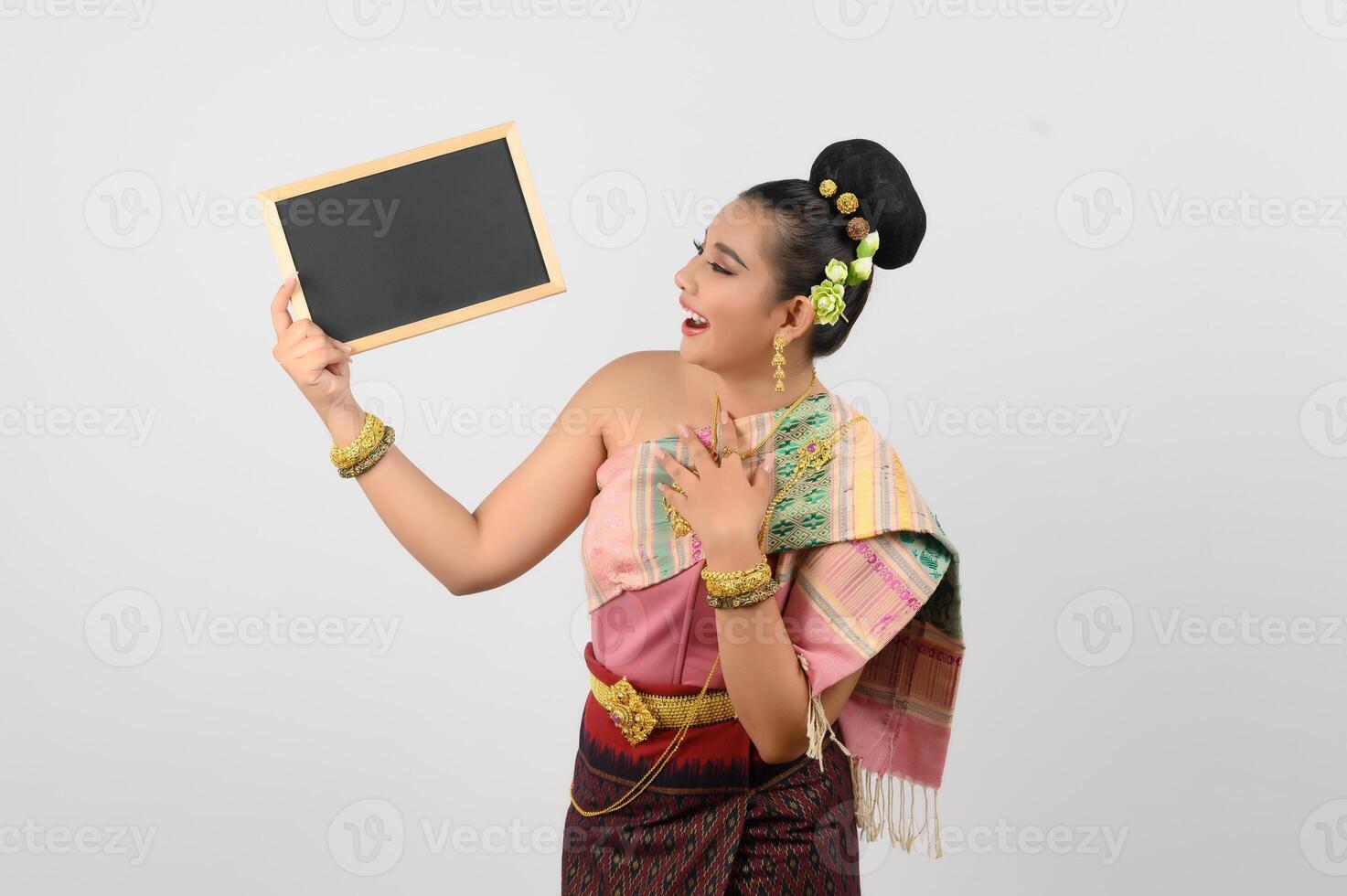 Young beautiful woman in northeastern dress holding chalkboard posting photo