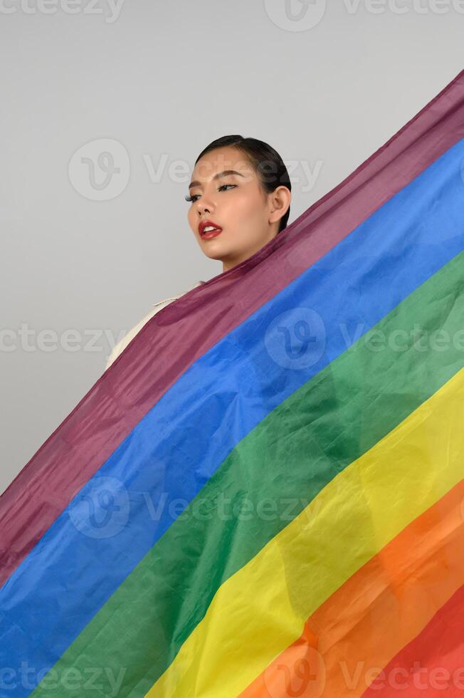 Pretty woman LGBQ pose with muli-color flag photo