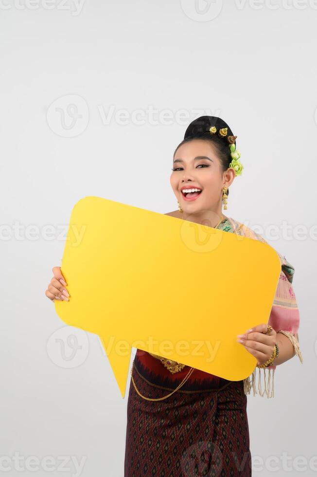 Young beautiful woman in Thai lanna costume with blank speech bubble sign photo