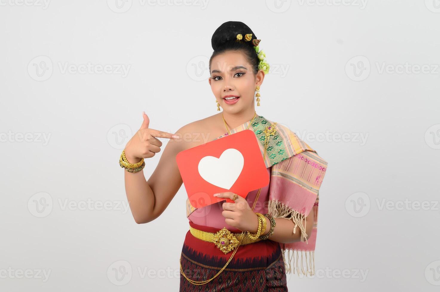 Young beautiful woman in Thai northeastern costume with card in heart symbol photo