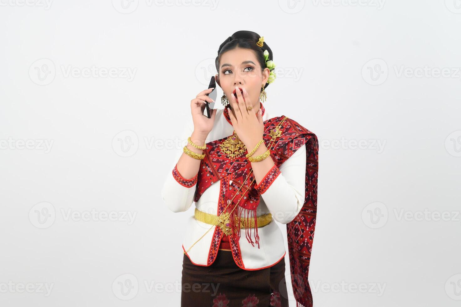 Portrait of Beautiful Thai Woman in Traditional Clothing Posing with smartphone photo