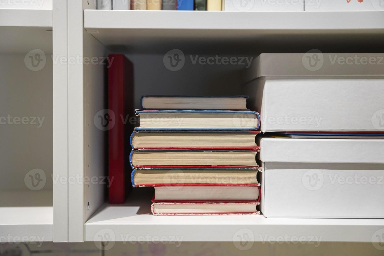 home bookshelf with books, textbooks and folders photo