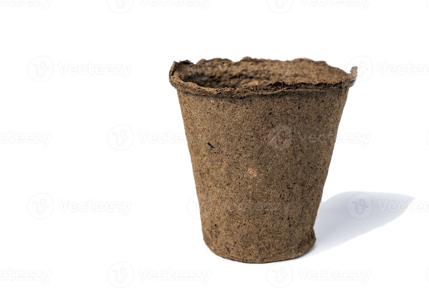 an empty peat pot for seedlings isolated on a white background photo