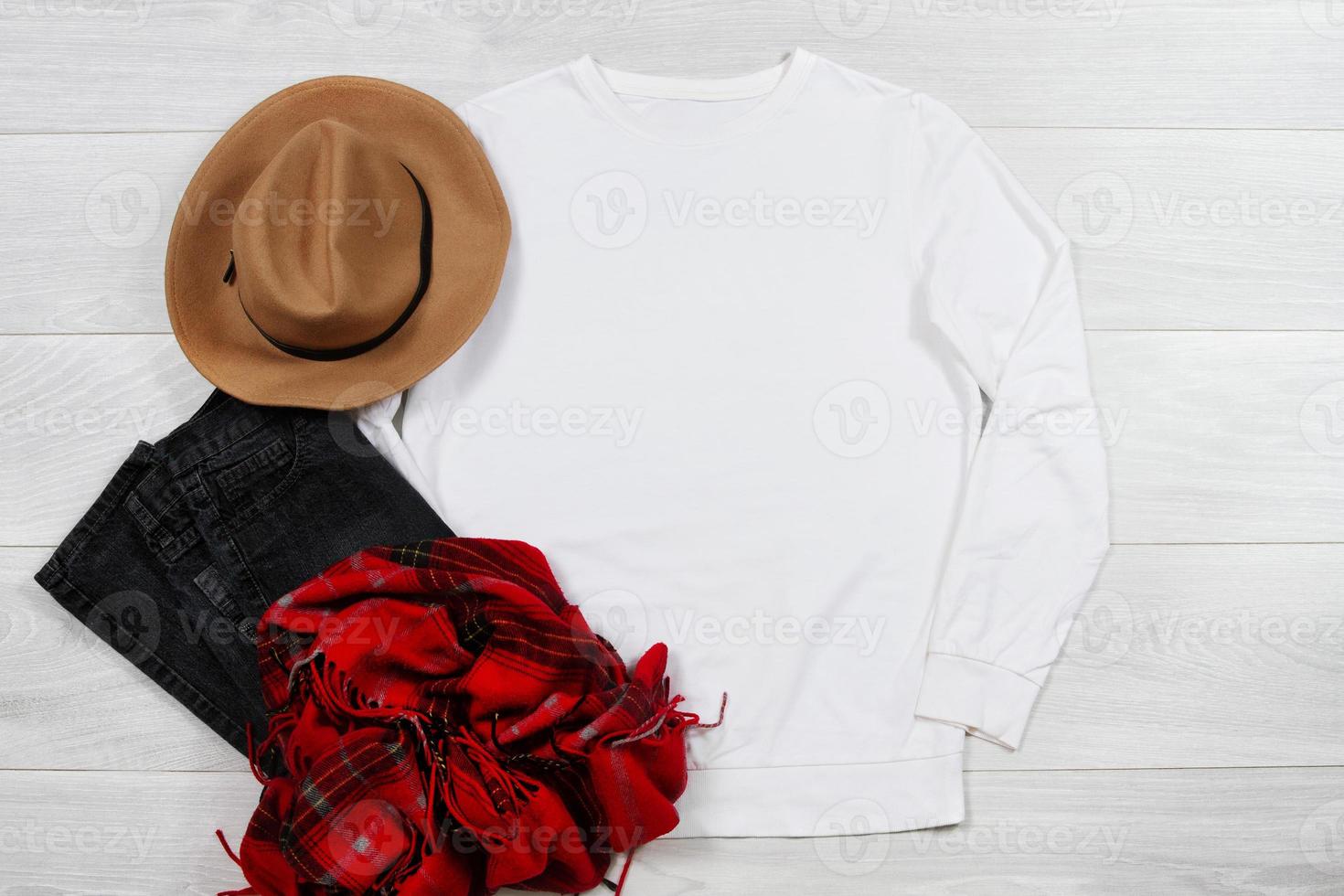 White Sweatshirt mockup. Template blank shirt top view on white wooden background. Winter outfit on wood floor. Woman fashion clothes. Spring look of today. Female Jeans, hat, scarf accessories photo