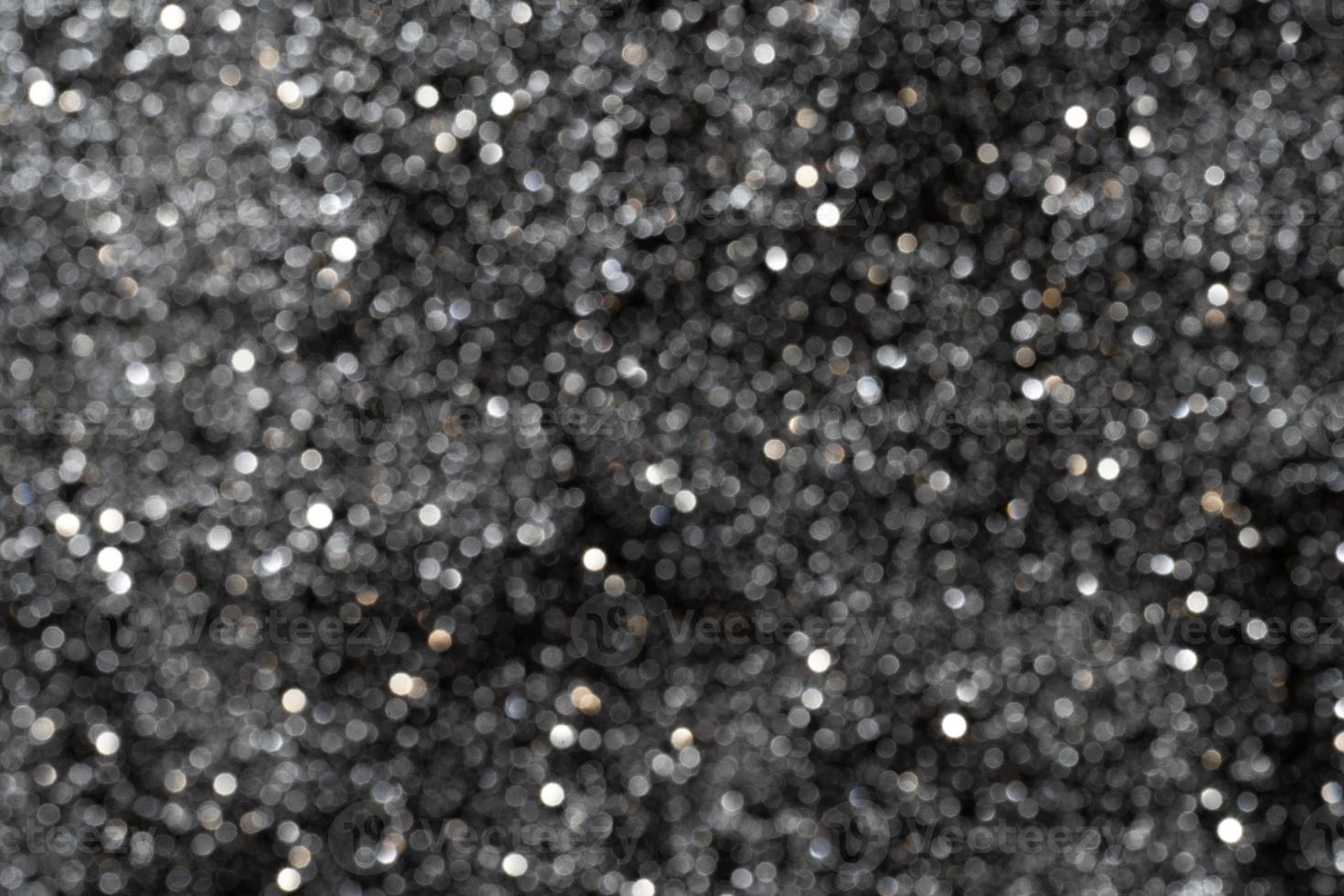 Black glitter sparkles unfocused photo