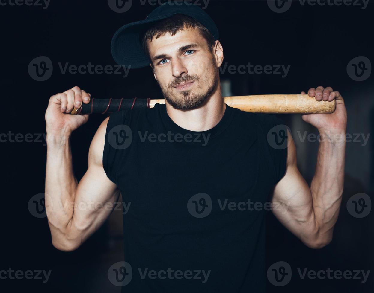 Muscular man with baseball bat photo
