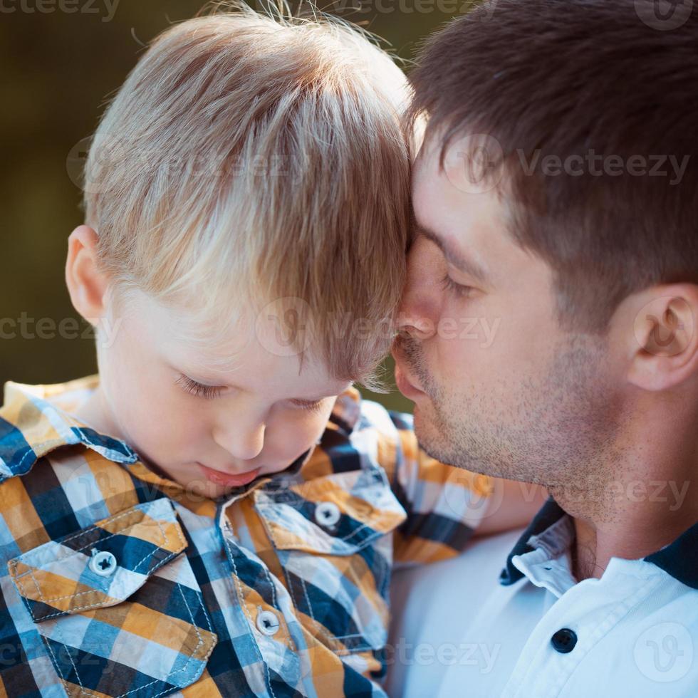 Father and his baby son having fun in the park photo