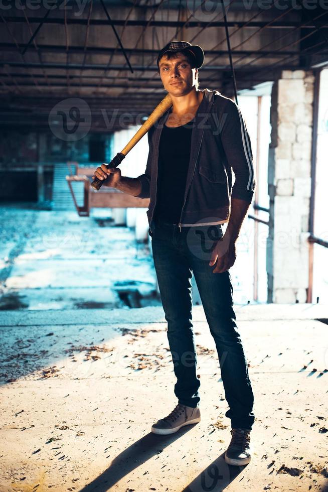 Man with baseball bat on the ruins photo