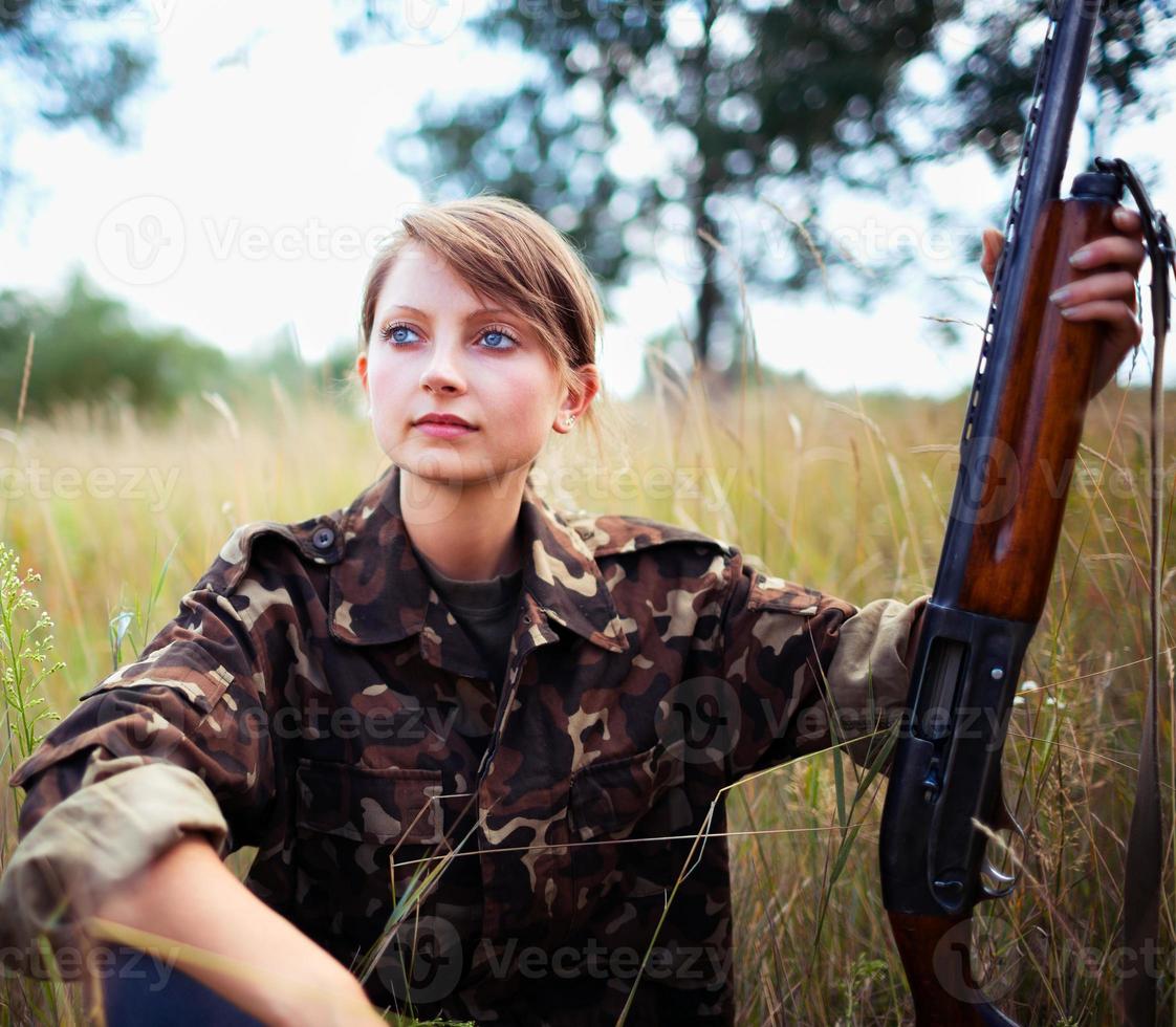 Young beautiful girl with a shotgun photo