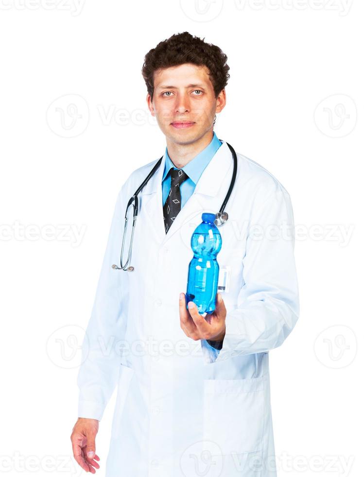 Portrait of a male doctor holding bottle of water on white background photo