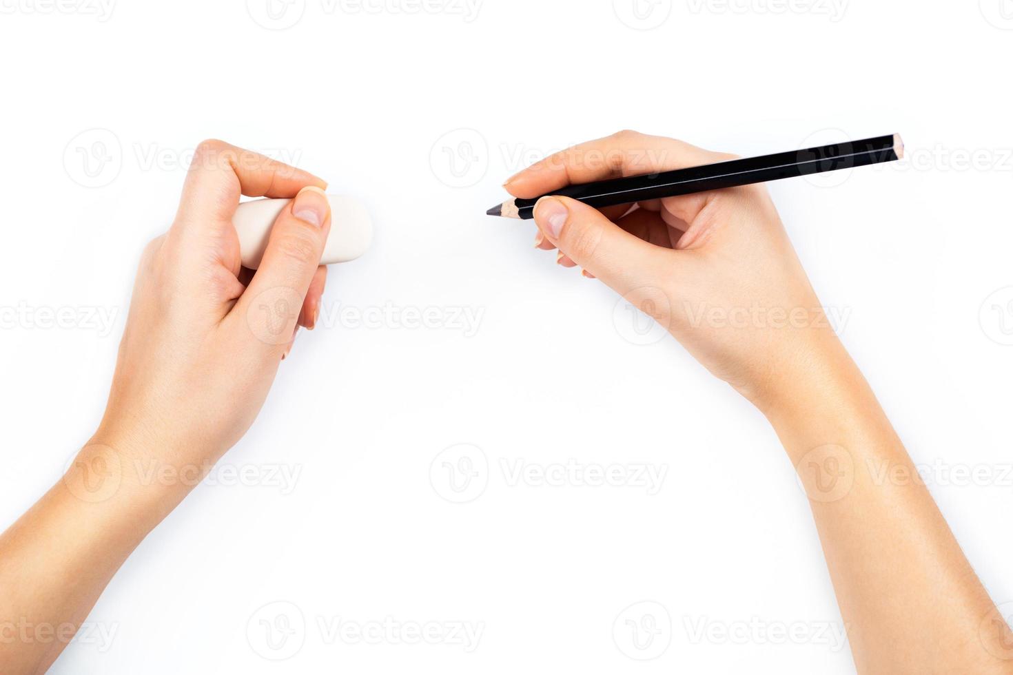 Human hands with pencil and erase rubber writting something photo