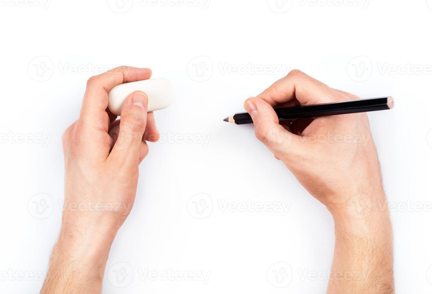 Human hands with pencil and erase rubber writting something photo