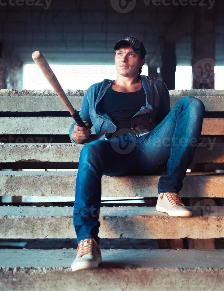 Man with baseball bat on the ruins photo