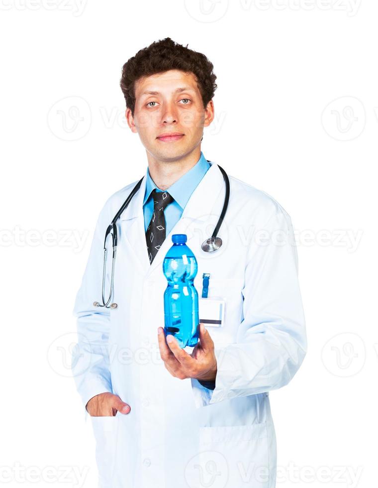 Portrait of a male doctor holding bottle of water on white photo