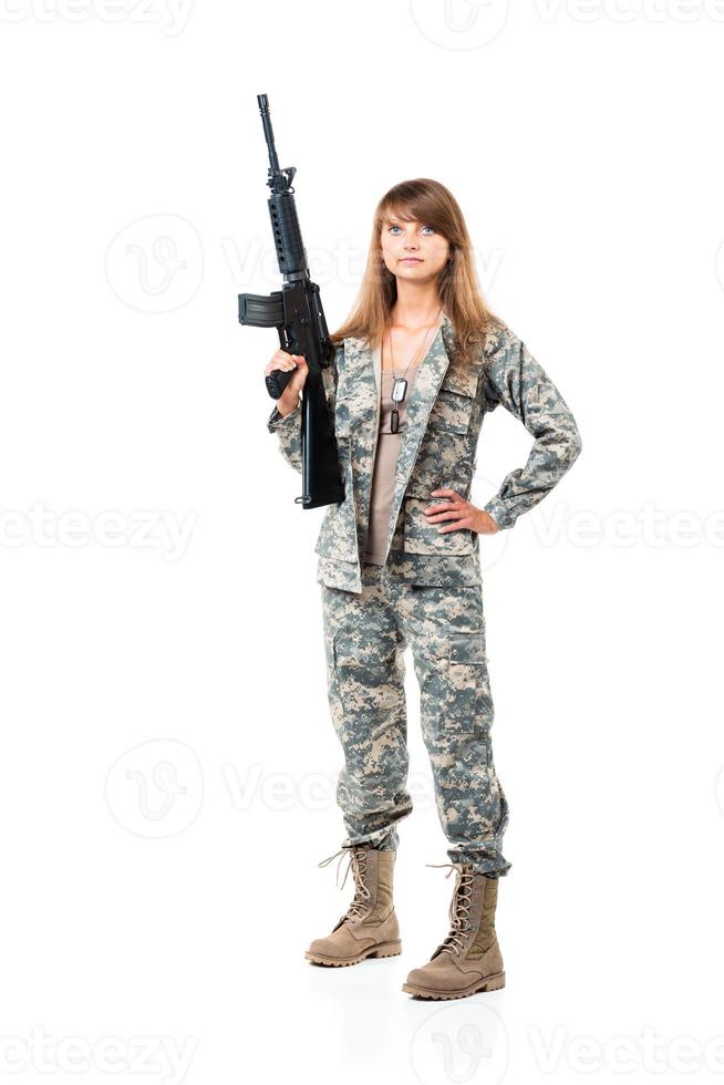 Soldier young beautyful girl dressed in a camouflage with a gun in his hand on white photo
