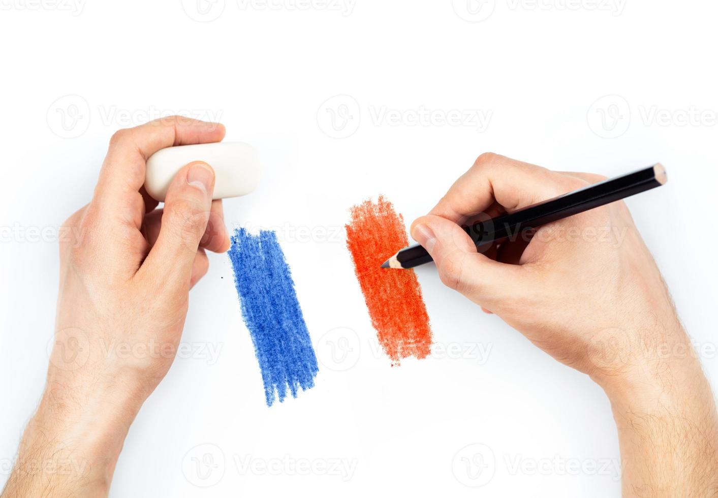 Man's hands with pencil draws flag of France on white photo
