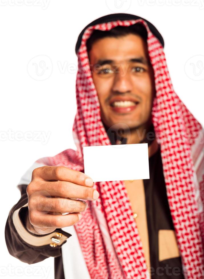 Young smiling arab showing business card in hand isolated on white photo