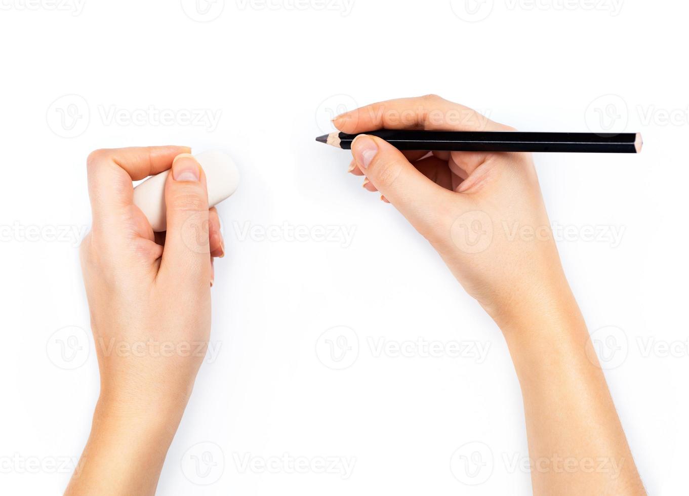 Human hands with pencil and erase rubber writting something on white photo