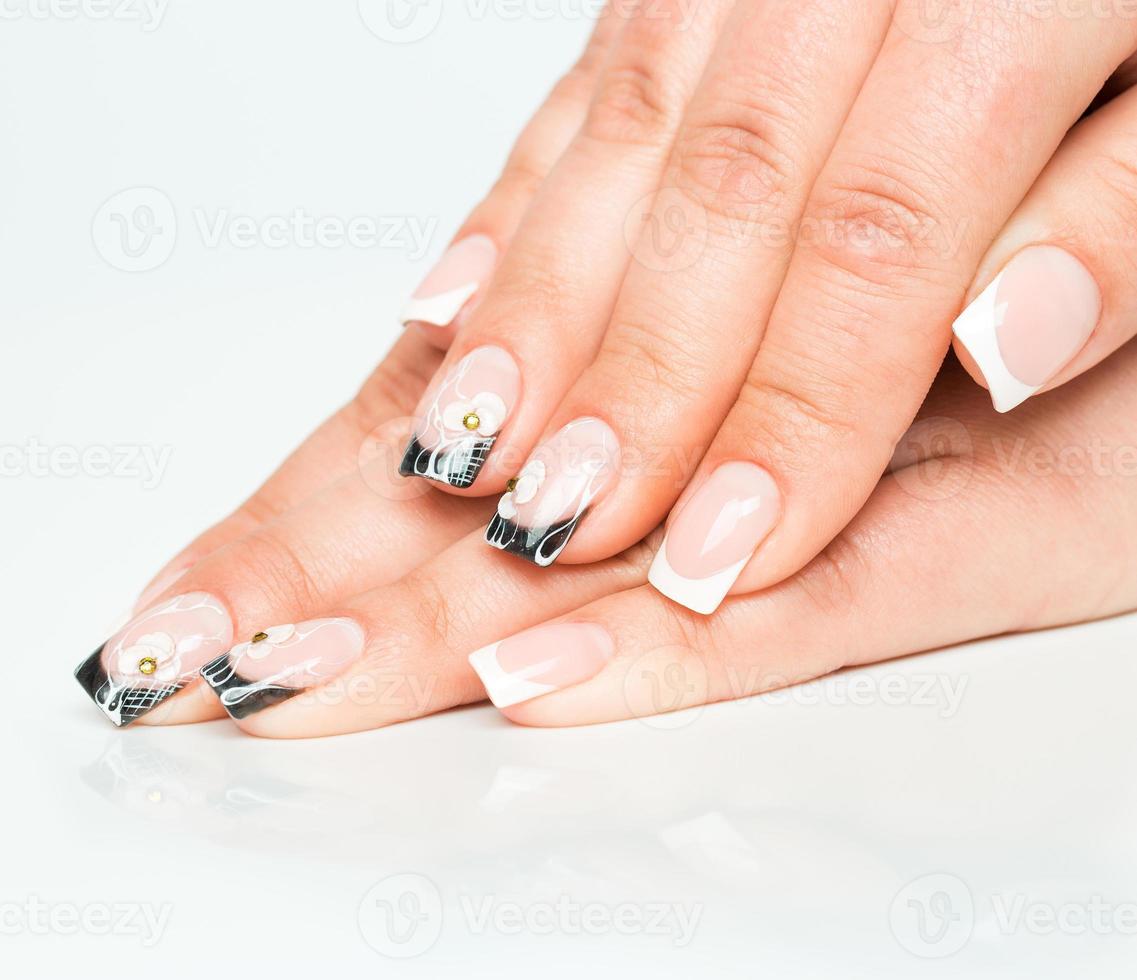 Beautiful female hands with manicure on a light photo