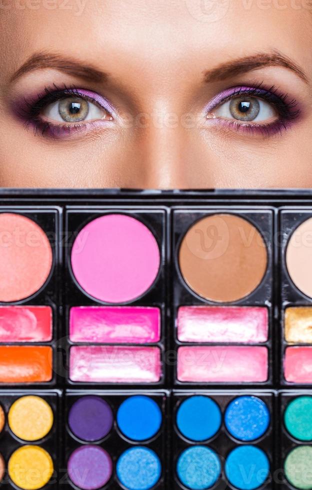 Closeup of beautiful womanish eyes with makeup kit photo